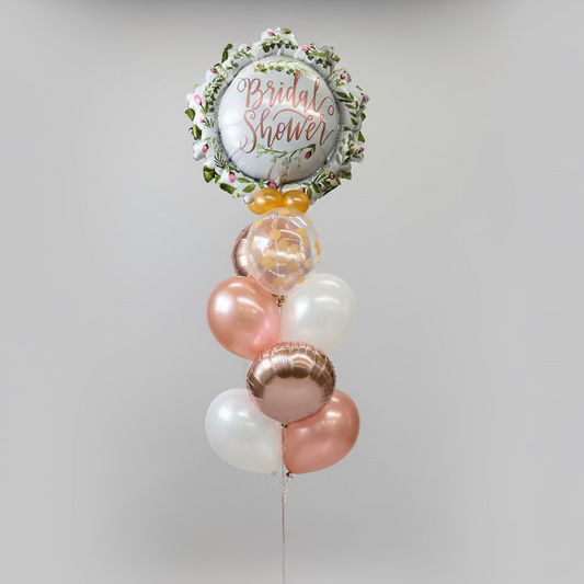 Balloons with 'Bridal Shower' text in a store aisle with greeting cards
